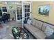 Sunroom with tiled floor, seating area, and a view of the garden at 1641 Lake Marion Dr, Apopka, FL 32712