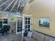 Bright sunroom with a sofa, table, and access to the backyard at 1641 Lake Marion Dr, Apopka, FL 32712