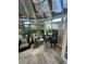 Sunroom with tiled floor, wicker furniture, and skylights at 1641 Lake Marion Dr, Apopka, FL 32712