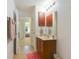 Small bathroom with wood vanity, single sink, and view of bedroom at 218 Black Springs Ln, Winter Garden, FL 34787
