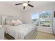 Bedroom with a queen bed, ceiling fan, and large window at 218 Black Springs Ln, Winter Garden, FL 34787