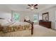 Spacious bedroom with a sleigh bed, ceiling fan, and dresser at 218 Black Springs Ln, Winter Garden, FL 34787
