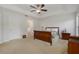 Bright bedroom with sleigh bed, ceiling fan, and access to bathroom at 218 Black Springs Ln, Winter Garden, FL 34787