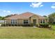 Charming single-story home with well-manicured lawn, beautiful landscaping, and a welcoming front entrance at 218 Black Springs Ln, Winter Garden, FL 34787