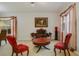 Cozy living room featuring a vintage couch and two red armchairs at 218 Black Springs Ln, Winter Garden, FL 34787