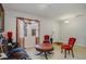 Bright living room featuring a comfy red couch and antique coffee table at 218 Black Springs Ln, Winter Garden, FL 34787