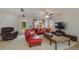 Relaxing living room, featuring a red sectional sofa and a large TV at 218 Black Springs Ln, Winter Garden, FL 34787
