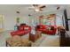Spacious living room with red couches and a wooden coffee table at 218 Black Springs Ln, Winter Garden, FL 34787