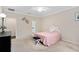 Light and airy bedroom with carpeted floors and access to a bathroom at 2714 Stargrass Cir, Clermont, FL 34715