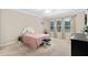 Cozy bedroom with carpeted floors, a queen-size bed, and ample natural light at 2714 Stargrass Cir, Clermont, FL 34715