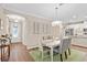 Spacious dining room with a light-colored table, chairs, and a green rug at 2714 Stargrass Cir, Clermont, FL 34715