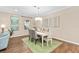 Bright dining room features hardwood floors and a light-colored table at 2714 Stargrass Cir, Clermont, FL 34715