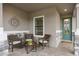 Relaxing front porch with wicker seating and a view of the front door at 2714 Stargrass Cir, Clermont, FL 34715