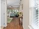 Bright hallway with hardwood floors and views of the living and dining areas at 2714 Stargrass Cir, Clermont, FL 34715