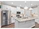 Modern kitchen with white cabinets, stainless steel appliances, and granite countertops at 2714 Stargrass Cir, Clermont, FL 34715
