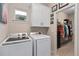 Bright laundry room, featuring washer, dryer, and ample storage at 2714 Stargrass Cir, Clermont, FL 34715