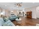 Open living space showcasing hardwood floors, a view of the kitchen, and comfortable seating at 2714 Stargrass Cir, Clermont, FL 34715