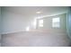 Large bedroom with carpet, neutral walls, and two windows at 2746 Stanwood Dr, Kissimmee, FL 34743