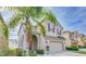 Two-story house with neutral siding, two-car garage, and palm tree at 2746 Stanwood Dr, Kissimmee, FL 34743