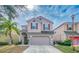 Two-story house with neutral siding, two-car garage, and landscaping at 2746 Stanwood Dr, Kissimmee, FL 34743