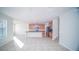 Open kitchen with island, wood cabinets, and tile floors at 2746 Stanwood Dr, Kissimmee, FL 34743