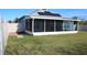 Backyard view showing the screened-in patio and a portion of the grassy lawn at 515 Haywood Ln, Lake Alfred, FL 33850