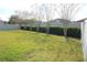Landscaped backyard with a fence at 515 Haywood Ln, Lake Alfred, FL 33850