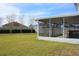 View of screened in porch with lush green backyard, bordered by privacy fence at 515 Haywood Ln, Lake Alfred, FL 33850