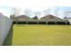 View of lush green backyard surrounded by white privacy fence and greenery at 515 Haywood Ln, Lake Alfred, FL 33850