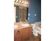 Bathroom with a double vanity, a large mirror, and a shower-tub combo with glass doors at 515 Haywood Ln, Lake Alfred, FL 33850