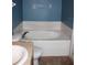 Elegant bathroom featuring a large bathtub, tile accents, and a vanity at 515 Haywood Ln, Lake Alfred, FL 33850