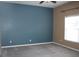 Bedroom featuring neutral carpet, a window, and a large blue accent wall at 515 Haywood Ln, Lake Alfred, FL 33850