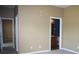 Neutral bedroom featuring two open doorways to a bathroom and another bedroom at 515 Haywood Ln, Lake Alfred, FL 33850