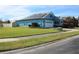 One-story home with solar panels, white garage door, and landscaped lawn at 515 Haywood Ln, Lake Alfred, FL 33850