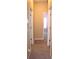 A hallway with carpeted floor and doors leading to other rooms at 515 Haywood Ln, Lake Alfred, FL 33850