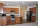 Modern kitchen featuring stainless steel appliances, granite counters, and ample cabinet space at 515 Haywood Ln, Lake Alfred, FL 33850