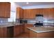 Kitchen featuring wood cabinets, granite countertops, backsplash, and stainless appliances at 515 Haywood Ln, Lake Alfred, FL 33850