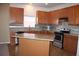 Kitchen featuring wood cabinets, granite countertops and stainless steel appliances at 515 Haywood Ln, Lake Alfred, FL 33850