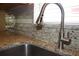 Close-up of kitchen sink featuring granite countertops and a stainless steel faucet at 515 Haywood Ln, Lake Alfred, FL 33850