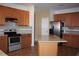 Kitchen featuring wood cabinets, granite countertops, backsplash, and stainless appliances at 515 Haywood Ln, Lake Alfred, FL 33850