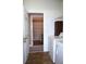 Bright laundry room with tile flooring, washer and dryer, and adjacent bathroom entrance at 515 Haywood Ln, Lake Alfred, FL 33850