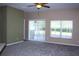 Open living room with carpet and sliding glass doors to the outside at 515 Haywood Ln, Lake Alfred, FL 33850