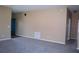 A cozy living room is enhanced by neutral paint, plush carpeting and a large, blue front door at 515 Haywood Ln, Lake Alfred, FL 33850