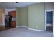 Open living space showcasing neutral walls, carpet, and stainless steel appliances at 515 Haywood Ln, Lake Alfred, FL 33850