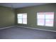 Living room featuring two large windows with hardwood flooring and a chandelier at 515 Haywood Ln, Lake Alfred, FL 33850