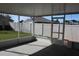 View from the screened patio overlooking the grassy fenced backyard at 515 Haywood Ln, Lake Alfred, FL 33850
