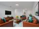 Mid-century modern living room features brown leather couches at 5215 Tanzanite Dr, Mount Dora, FL 32757