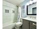 Modern bathroom with a shower/tub combo, gray vanity, and white tile at 5271 Whitstable Way # 1, Orlando, FL 32812