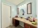 Elegant bathroom with a vanity, large mirror, and tile countertops at 5271 Whitstable Way # 1, Orlando, FL 32812