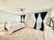 Spacious bedroom with large bed, ceiling fan, and ample natural light at 5271 Whitstable Way # 1, Orlando, FL 32812